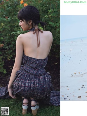 A woman walking on a beach near the ocean.