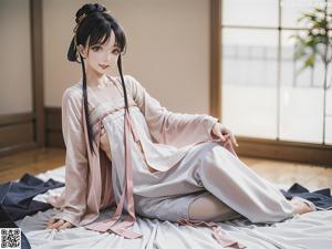 A woman in a white kimono is posing on a bed.