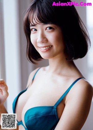 A woman in a white lingerie posing in a bathroom.