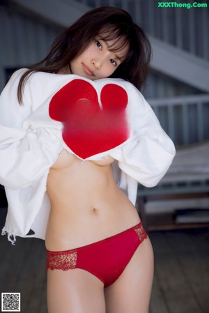 A woman sitting on a swing in a park.