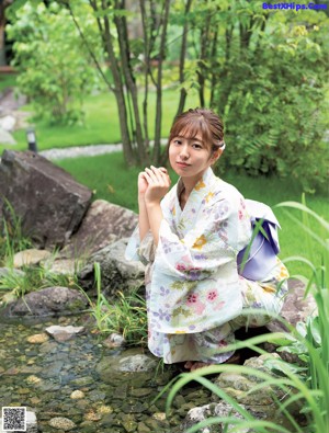 A woman wearing a yellow top and a straw hat.