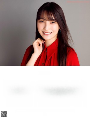 A woman in a red dress posing for a picture.