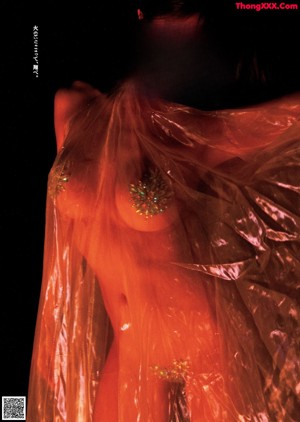 A woman standing in front of a fire covered in plastic.
