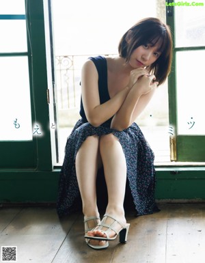 a japanese woman in a red and black plaid shirt is posing for the camera