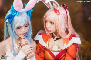 A couple of women dressed in costumes standing next to each other.